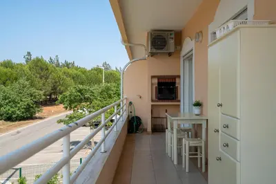a balcony with a view of a kitchen and a table at VILAMOURA Two Bedroom Near Praia Falésia in Quarteira