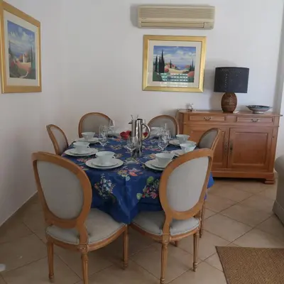 a dining room table with a blue table cloth and chairs at Santos Villa in Quinta do Lago in Quinta do Lago