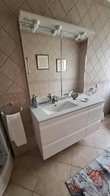 a bathroom with two sinks and a colorful rug at Santos Villa in Quinta do Lago in Quinta do Lago