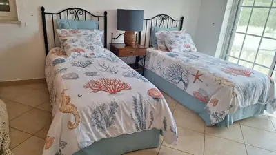 a room with a couch with a pillow on it at Santos Villa in Quinta do Lago in Quinta do Lago