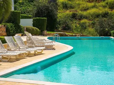 a swimming pool with lounge chairs and a swimming pool at Serenity 06 House by Stay ici Algarve Holiday Rental in Albufeira