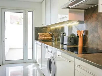 a kitchen with a washing machine and a sink at Serenity 06 House by Stay ici Algarve Holiday Rental in Albufeira