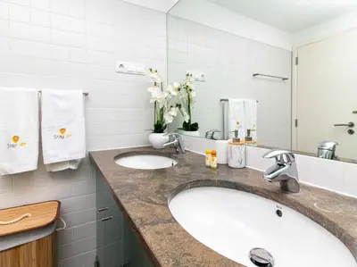 a bathroom with two sinks and a large mirror at Serenity 06 House by Stay ici Algarve Holiday Rental in Albufeira