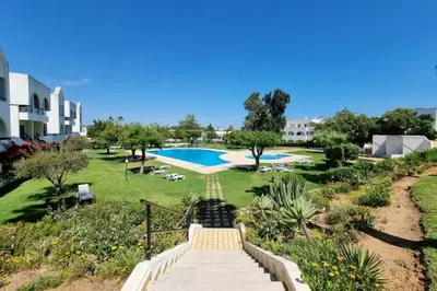 a staircase leading to a swimming pool in a park at Blue Palmtree in Albufeira