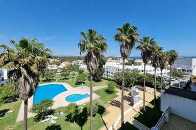 a view of a resort with a pool and palm trees at Blue Palmtree in Albufeira