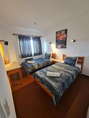 a room with two beds and a desk at S Soares T1 Sil Choro in Albufeira