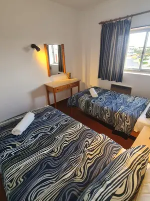 a hotel room with two beds and a window at S Soares T1 Sil Choro in Albufeira