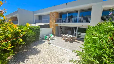 a house with a patio and a table in front of it at Segolene Design in Albufeira