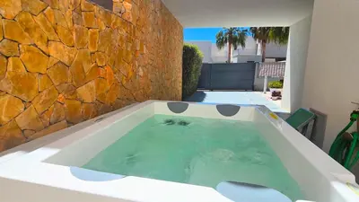 a bath tub in a yard with a stone wall at Segolene Design in Albufeira