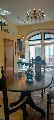 a dining room with a table and a chandelier at Grand Studio 56 in Faro