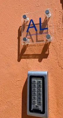 a cell phone is attached to the side of a wall at Grand Studio 56 in Faro