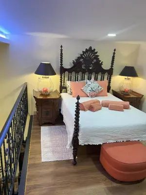 a bedroom with a bed and two tables and two lamps at Grand Studio 56 in Faro