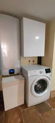 a washer and dryer in a corner of a room at Grand Studio 52 in Faro