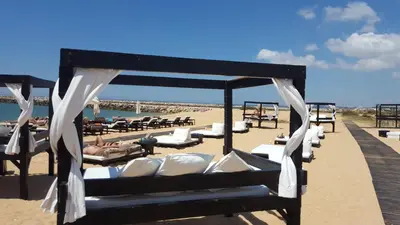 a row of lounge chairs on the beach at Vilamoura Dream House QR2 in Quarteira