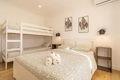 a bedroom with two white bunk beds in it at Cosy apartment in Albufeira, OURA ST in Albufeira