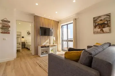 a living room with a couch and a television at Cosy apartment in Albufeira, OURA ST in Albufeira