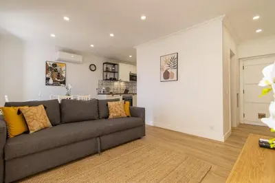 a living room with a couch and a kitchen at Cosy apartment in Albufeira, OURA ST in Albufeira