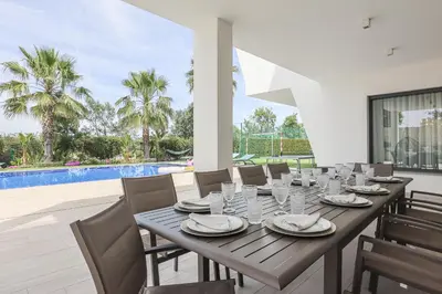 a villa with a swimming pool and a house at Villa Moroz - BY BEDZY in Almancil