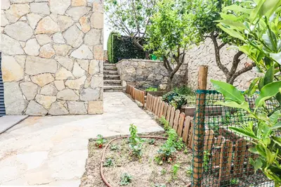 a garden with pink flowers and green grass at Villa Moroz - BY BEDZY in Almancil