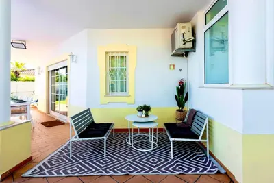 a room with a table and two chairs and a patio at Casa Luna with Saltwater Pool in Olhos de Água