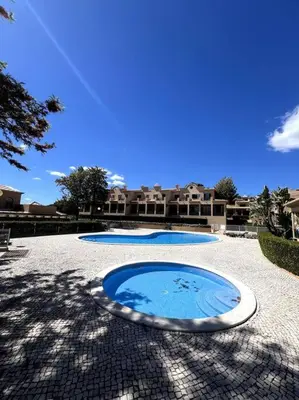 two pools of water sitting on a tiled patio at Moradia Almorávia in Olhos de Água