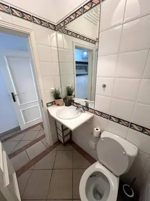 a bathroom with a toilet and a sink and a mirror at Moradia Almorávia in Olhos de Água