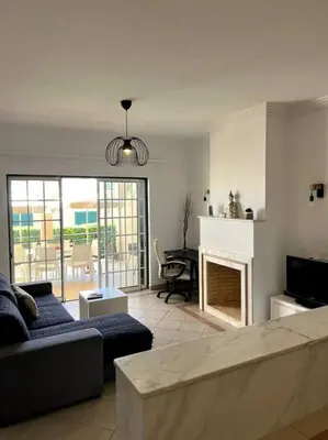 a living room with a couch and a fireplace at Moradia Almorávia in Olhos de Água