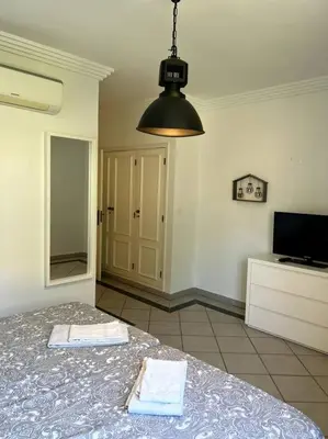 a bedroom with a bed with two towels on it at Moradia Almorávia in Olhos de Água