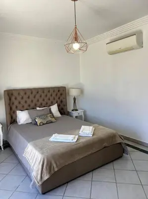 a bedroom with a bed with two towels on it at Moradia Almorávia in Olhos de Água