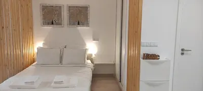 a small bedroom with a white bed with two pillows at Casa de Praia em São Rafael in Albufeira