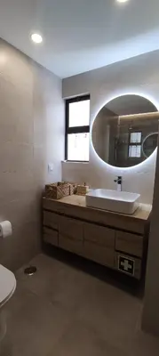 a bathroom with a sink and a mirror at Casa de Praia em São Rafael in Albufeira