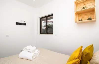 a room with a bed with towels on it at Amelie Old Town Apartment in Albufeira