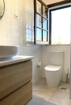 a bathroom with a toilet and a sink at VM Relax Beautiful villa with pool! VILAMOURA! in Quarteira