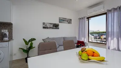 a kitchen with a bowl of fruit on a counter at Pateo Loft in Albufeira