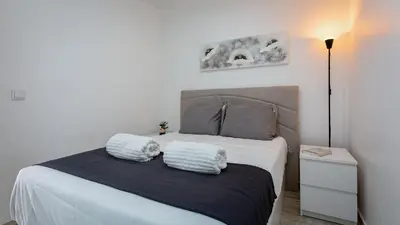 a bedroom with a bed with two pillows on it at Pateo Loft in Albufeira