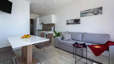 a living room with a couch and a white table at Pateo Loft in Albufeira
