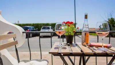 a table with two glasses of wine and a bottle at Pateo Loft in Albufeira