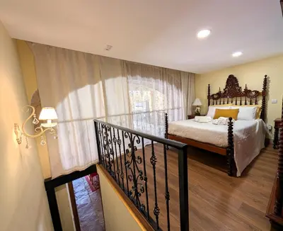 a bedroom with a bed and a balcony at Grand Studio 27 in Faro
