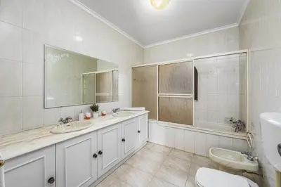 a white bathroom with two sinks and a tub at Villa Vista Mar by Villa Plus in Terras Novas