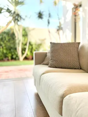 a couch sitting in a living room next to a window at Narciso Townhouse in Faro