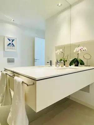 a white bathroom with a sink and a mirror at Narciso Townhouse in Faro