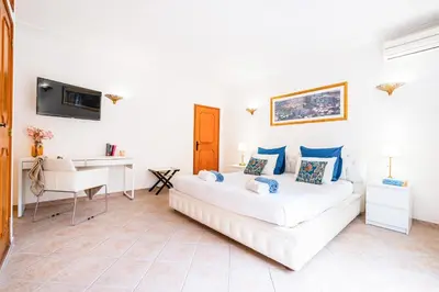 a white room with a bed and a desk at Villa Los Angeles by Algarve Vacation in Boliqueime