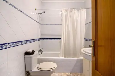 a bedroom with a bed and a large window at V2 a 400 m da Praia da Falésia in Albufeira