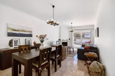 a dining room and living room with a dining table at V2 a 400 m da Praia da Falésia in Albufeira
