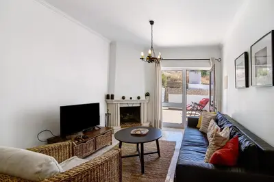 a living room with a couch and a fireplace at V2 a 400 m da Praia da Falésia in Albufeira