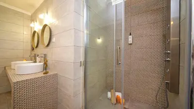 a bathroom with a shower and a sink at Villa Del Sol by Algarve Vacation in Quarteira