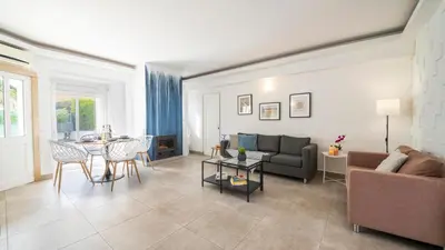 a living room with a couch and a table at Villa Del Sol by Algarve Vacation in Quarteira
