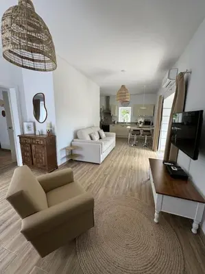 a living room with a couch and a table at Casa Nova Vida in Paderne
