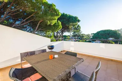 a patio with a table and chairs on a balcony at Townhouse Flores in Faro