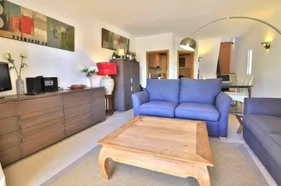 a living room with a blue couch and a coffee table at Townhouse Flores in Faro